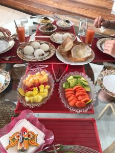 a table with plates of food on top at Kande Home in Kandy