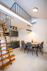 a dining room with a table and chairs and a staircase at Lasa Pur Dir in Piran