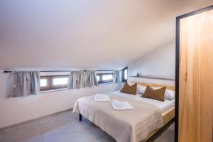 a bedroom with a bed with two towels on it at Lasa Pur Dir in Piran