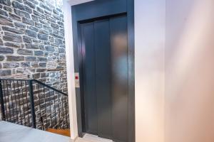 a glass elevator in a building with a brick wall at Lasa Pur Dir in Piran