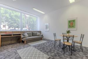 a living room with a couch and a table and chairs at Penzion Brixen in Lipnice nad Sázavou