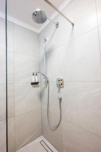a shower with a shower head in a bathroom at Lasa Pur Dir in Piran +34 photos