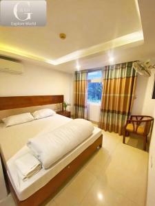 a bedroom with a large bed and a window at Hanoi Gold Hotel Near Bach Mai in Hanoi