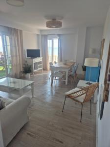 a living room with a couch and a table at TOP APARTMENT! Frente al mar y gran terraza in Ayamonte