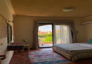 a bedroom with a bed and a large window at Luxury Chalet - La Hacienda in Ras Sedr +19 photos