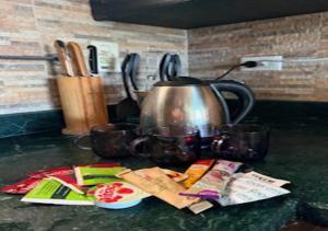 a tea kettle sitting on a counter with packets of food at Luxury Chalet - La Hacienda in Ras Sedr