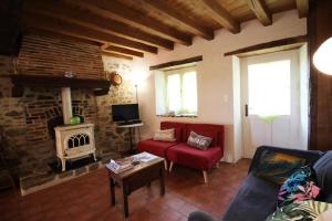 a living room with a couch and a fireplace at Mounismes du bas in Saint-Ouen-sur-Gartempe