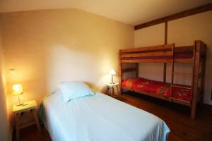 a bedroom with a bed and a bunk bed at Mounismes du bas in Saint-Ouen-sur-Gartempe +9 photos