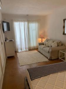 a living room with a couch and a large window at Gorgeous Apartment in Jesús in Nuestra Señora de Jesus
