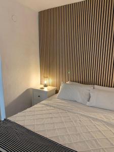 a bedroom with a large bed with a wooden wall at Gorgeous Apartment in Jesús in Nuestra Señora de Jesus