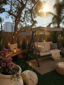 a patio with a couch under a gazebo at וילה נחל טביה in Arad
