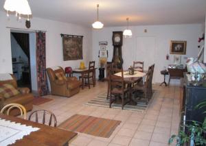 a living room with a couch and a table and chairs at Chambres d'hôtes de charme "La Tour Richelieu" in Martres-de-Veyre