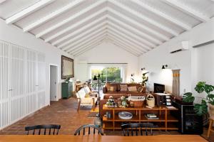 a living room with white ceilings and a couch at Abacatus Farmhouse in Tavira