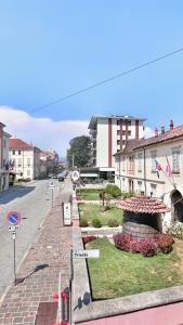 a street in a small town with a street sign at Il Grappolo in Gattinara