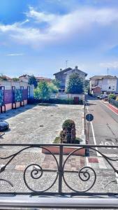 a view of an empty parking lot from a gate at Il Grappolo in Gattinara +4 photos