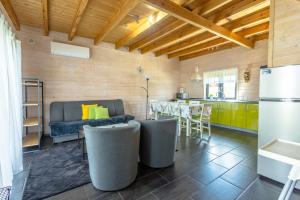 a kitchen with a couch and a table in a room at Domki Kalipso in Sarbinowo +86 photos