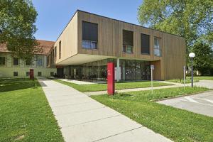 a building with a red post box in front of it at Bildungshaus Schloss Retzhof in Wagna +7 photos