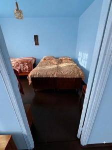 a bedroom with two beds in a blue room at Antarut Garden House in Antarut