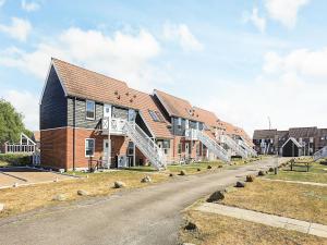 a building with a staircase on the side of a road at Møn - Klintholm Harbour in Borre +56 photos