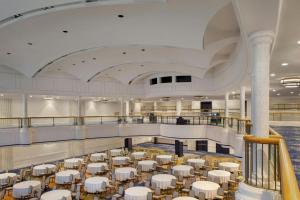 a large room with white tables and chairs at Hotel Cleveland Autograph Collection in Cleveland