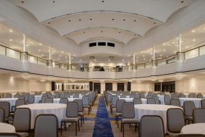 a large banquet hall with white tables and chairs at Hotel Cleveland Autograph Collection in Cleveland