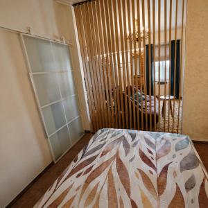 a bedroom with a bed and a chandelier at Old town boutique apartaments in Ukmergė