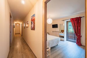 a hotel room with a bed and a window at Meublé la Ciastella in Vinadio