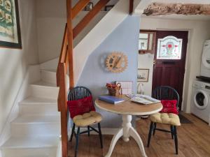 a dining room with a table and two chairs at The Poop Deck in Upton upon Severn