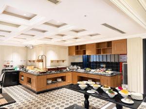 a large kitchen with a table with food on it at Palais De Sapa Boutique Hotel in Sapa