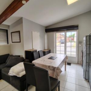 a living room with a table and a couch at L’Adresse 262 