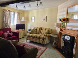 a living room with a couch and a fireplace at The Poop Deck in Upton upon Severn