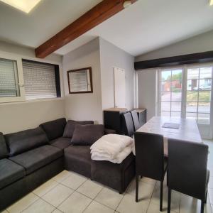 a living room with a couch and a table at L’Adresse 262 