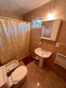 a bathroom with a toilet and a sink at La Posada del Hobbit in Villa Ventana
