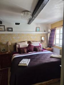 a bedroom with a large bed and a chandelier at The Poop Deck in Upton upon Severn