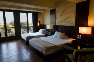 a hotel room with two beds and a balcony at هوتيل بوسيك - Bosque Hotel in Hurghada