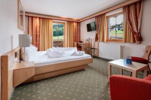 a hotel room with a bed and a table at Hotel Mariasteinerhof in Mariastein +53 photos
