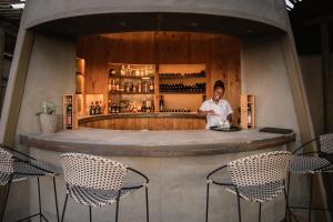 a man standing at a counter in a bar at Wolwedans Dune Camp in NamibRand