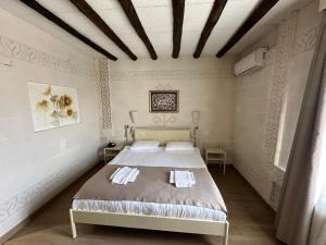 a bedroom with a bed with two towels on it at Cappadocia Mihran Sultan in Avanos