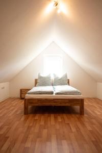 a bed in a loft with a window at Haus Figaro mit Hund in Wangerland