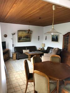 a living room with a couch and a table at Haus Horst in Schillig