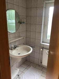 a bathroom with a sink and a mirror at Haus Horst in Schillig +15 photos