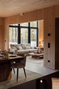 a living room with a couch and a table at Les Terrasses de Durbuy in Durbuy