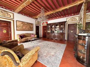 a living room with a couch and a chandelier at Villa Amore Tuscany in Capannori