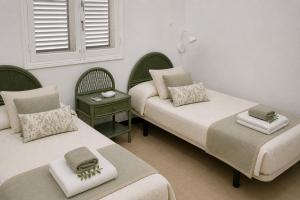 a bedroom with two beds and a window at Albaricoques Sun & Beach in Maspalomas +40 photos