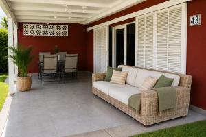 a porch with a couch on a patio at Albaricoques Sun & Beach in Maspalomas