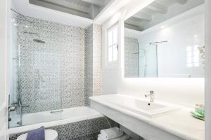 a white bathroom with a sink and a shower at San Marco Hotel and Villas in Houlakia +35 photos