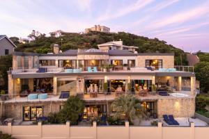 a house with a hill in the background at Alexander Guest House in Knysna