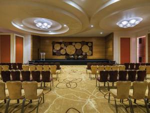 a conference room with chairs and a stage in it at Mövenpick Hotel du Lac Tunis in Tunis +198 photos
