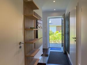 a hallway with wooden shelves and a door at Haus Strandhafer in Wangerland