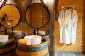 a bathroom with two sinks and two mirrors at Maison D'hôtes et Spa La Boucotte in Vellerot-lès-Vercel +72 photos
